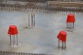 Three red buckets covering reinforcing bars on a construction si Royalty Free Stock Photo