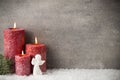 Three red candles on gray background, Christmas decoration. Advent mood. Royalty Free Stock Photo