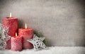 Three red candles on gray background, Christmas decoration. Advent mood. Royalty Free Stock Photo