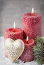 Three red candles on gray background, Christmas decoration. Advent mood. Royalty Free Stock Photo