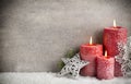 Three red candles on gray background, Christmas decoration. Advent mood. Royalty Free Stock Photo