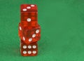 Three red casino dices on green cloth. The concept of online gambling. Copy space for text. Royalty Free Stock Photo