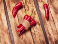 three red chili peppers on wooden Royalty Free Stock Photo