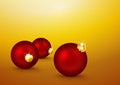 Three Red Christmas Balls lying on the Yellow Gold Background.