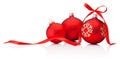 Three red Christmas baubles with ribbon bow isolated on white background Royalty Free Stock Photo