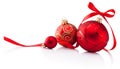 Three red Christmas decoration baubles with ribbon bow isolated on white background Royalty Free Stock Photo