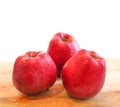 Red delicious apples on wooden table isolated on white background Royalty Free Stock Photo