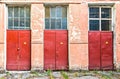 Three red doors bearing a danger label Royalty Free Stock Photo