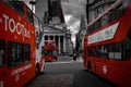 Three red double decker buses at Bank Station, London, UK, selective color