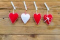 Three red felt hearts and one white. symbol for a family, love. On wooden background Royalty Free Stock Photo