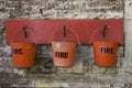 Fire buckets hanging on wall Royalty Free Stock Photo