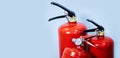 Three red fire extinguishers on a blue background Royalty Free Stock Photo