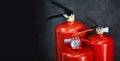Three red fire extinguishers on a dark background Royalty Free Stock Photo