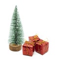 Three red gift boxes under the fir tree isolated on white background. Happy New Year and Marry Christmas concept Royalty Free Stock Photo