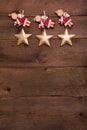 Three red and golden Christmas angels on old wooden background f Royalty Free Stock Photo