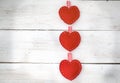 Three red hearts lie on the white wooden background Royalty Free Stock Photo