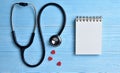 Three Red hearts with stethoscope, blank notepad.