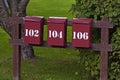 Three red mailboxes in a row with white text Royalty Free Stock Photo