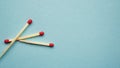 Three red matches are on a blue background Royalty Free Stock Photo