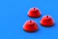 Three red metallic hotel bells on blue background. Administrator call