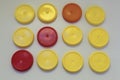 Three red and nine yellow plastic round lid for jars on a white background
