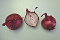 Three Red Onions on a simple background Royalty Free Stock Photo