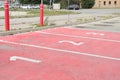 three red parking spots spaces with numbers 1 2 3 in each of them side by side. p