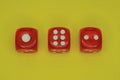 Three red plastic game cubes