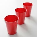 Three Red Plastic Party Cups Arranged in a Diagonal Line on a White Surface red cups Royalty Free Stock Photo