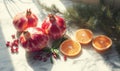 Three red pomegranates and two oranges are on a marble counter Royalty Free Stock Photo