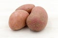 three red potatos background, close up Royalty Free Stock Photo