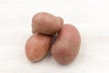 three red potatos background, close up