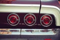 Three red rear tail lights from a vintage retro car with nostagic look Royalty Free Stock Photo