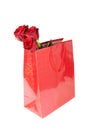 Three red roses in a red gift bag on white background Royalty Free Stock Photo