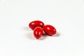 Three red soft gelatine capsules. Royalty Free Stock Photo