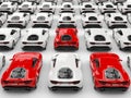 Three red sports cars stand out amongst many white cars