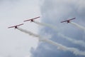 Three red sports planes make a parallel flight during an air show Royalty Free Stock Photo