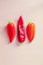 Three red sweet peppers from your own garden lie on a pink background Royalty Free Stock Photo