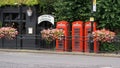 Three red telephone booths in Greenwich, London, England Royalty Free Stock Photo