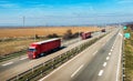 Three Red Trucks in line on a rural countryside highway Royalty Free Stock Photo