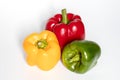 Three Red, Yellow, Green Peppers isolated on white background Royalty Free Stock Photo