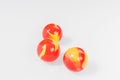 Three red yellow marbles isolated on white Royalty Free Stock Photo
