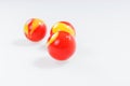 Three red yellow marbles on white Royalty Free Stock Photo