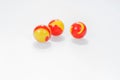 Three red yellow marbles on white Royalty Free Stock Photo