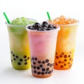 Three refreshing bubble tea drinks with tapioca pearls and green straws on white background Royalty Free Stock Photo