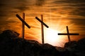 Three Religious Crosses Against a Dramatic Sky at Sunset