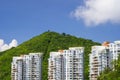 Three residential buildings against a mountain
