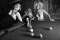 Three retro girls playing pool Royalty Free Stock Photo