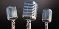 Three retro microphones on black background. 3d illustration