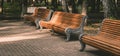 Three retro old bench benches in the park there are no people, sunset light creates shadows and overexposures, a little Royalty Free Stock Photo